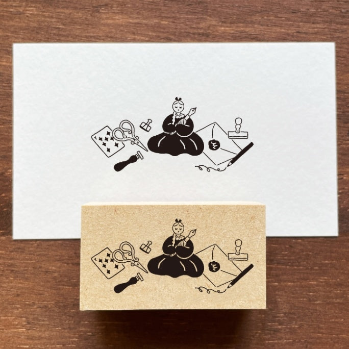 Stamp Marche Maru-Chan Stationery Land Wooden Stamp White card with black illustrations of a person playing a stringed instrument on a wooden surface.