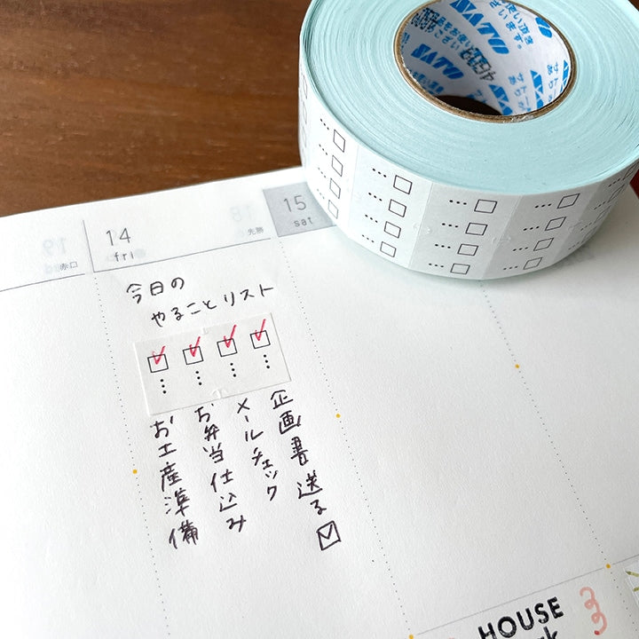 Stamp Marche Planner Label Sticker Roll - Checkbox Roll of checkered tape on a planner with handwritten notes