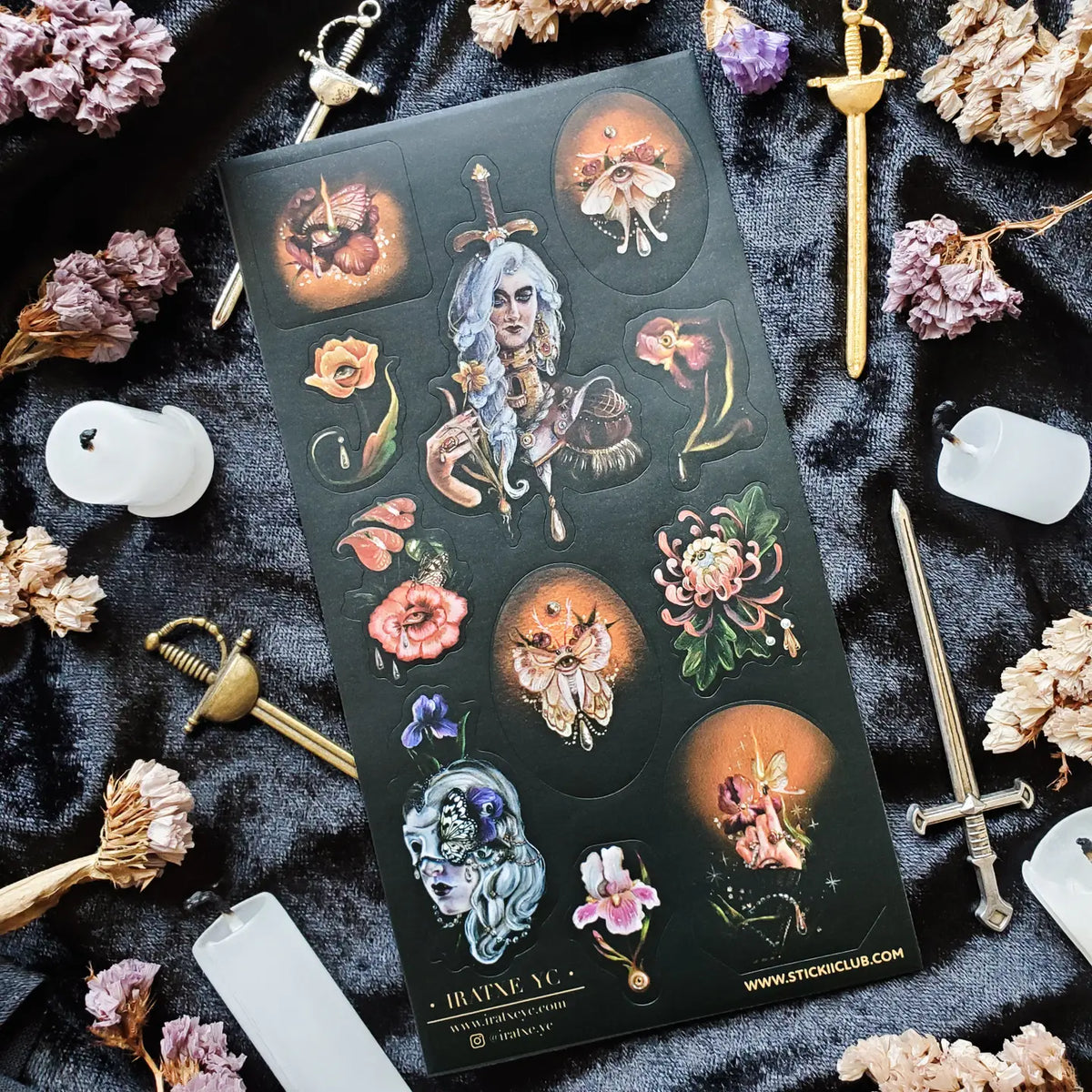 In @iratxe.yc’s shadowed garden, nothing is quite as it first appears. Jeweled flowers gaze back from curling stems, delicate moths wear watchful eyes, and a silver-haired guardian stands adorned in blossoms, gemstones, and armor. Rich with surreal beauty and dark botanical magic, this striking sheet reveals a forest where every petal may be hiding a secret.
Art by: @iratxe.yc
One sticker sheet is included.
Top Coating: None
Adhesive Layer: Paper
Backing Layer: Clear PET
Size:6.69"x3.54"
Weight-0.03oz