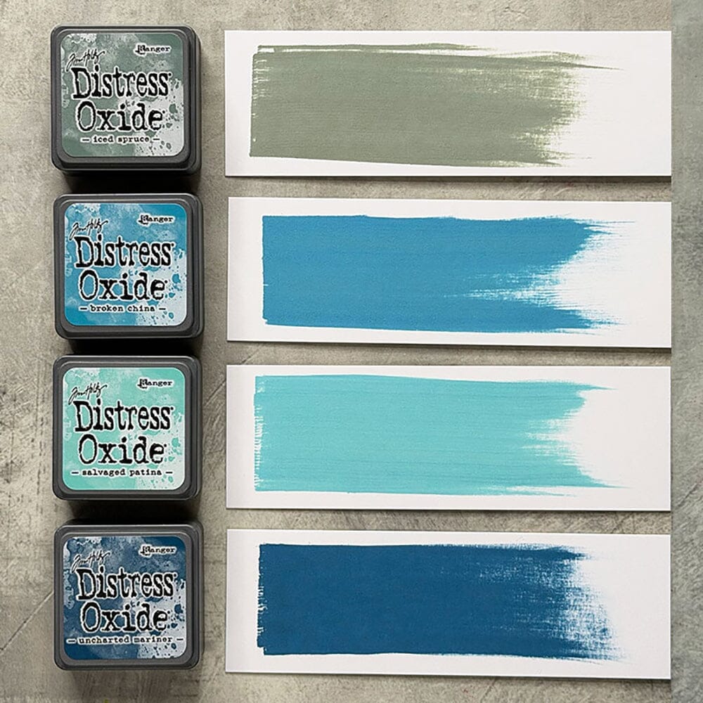Tim Holtz Distress Mini Oxide Ink Pads are a collection of 1 x 1 cubes featuring water-reactive dye & pigment ink fusion that creates an oxidized effect when sprayed with water.