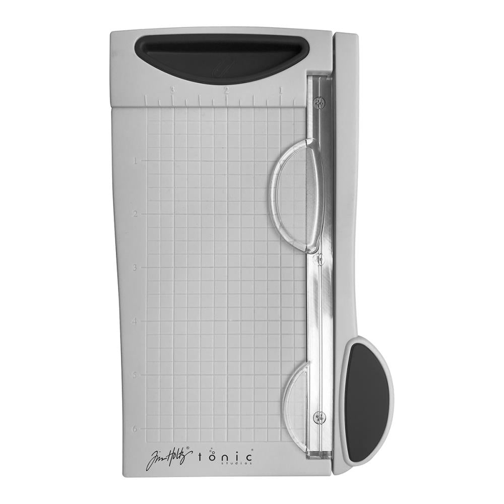 The Tim Holtz 6.25 inch / 16cm Mini Trimmer has many features not found in similar products. This product is portable and lightweight. It is perfect for trimming photographs and creating card fronts.
Features include: Hardened steel precision ground blade, Molded in measuring grid, 6.25 inch / 16cm cutting blade length and Finger guard that holds your paper in position for the perfect cut.
Width 5.4 in / 13.72 cm
Height 1.7 in /  