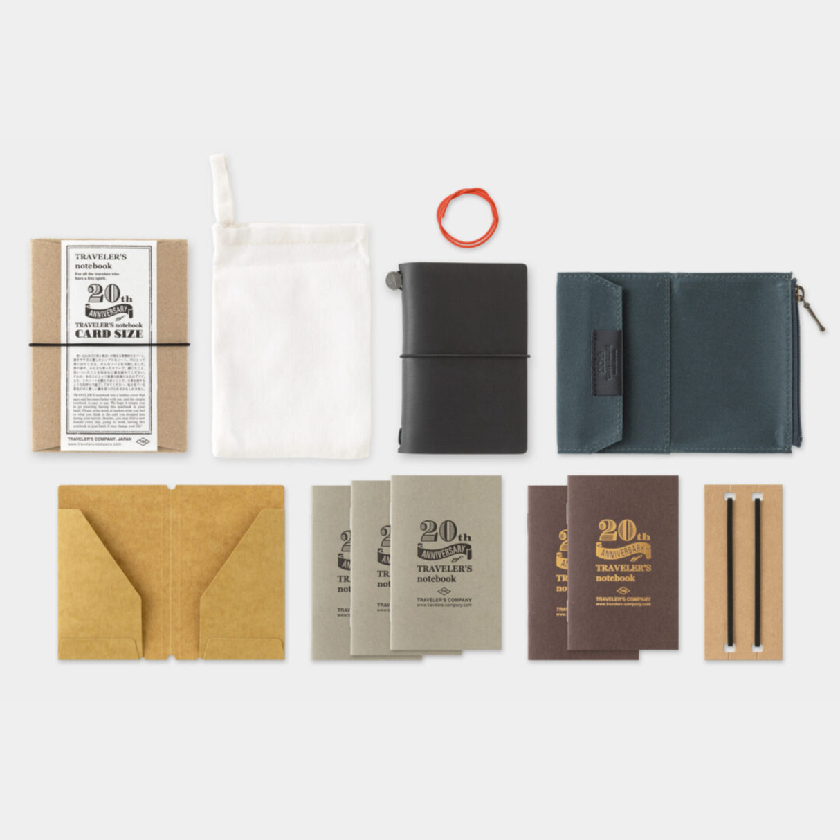 To commemorate this 20th anniversary, we’ve created a new size of TRAVELER’S notebook.
It is TRAVELER’S notebook Card Size. This TRAVELER’S notebook is always with you, even in your daily life. Whether it’s a sudden idea, information you learned or overheard, or something important you don’t want to forget— whenever and wherever you feel like writing, you can quickly grab the notebook and jot it down.
This set includes TRAVELER’S notebook Card Size, Refill Notebooks, Cotton Zipper Case, Kraft Paper Folder