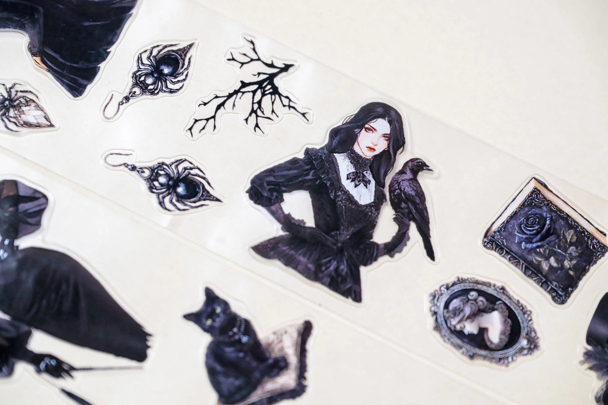 tep into the world of Victorian elegance with this unique transparent PET tape by CoraCreaCrafts. Designed with an intricate mix of gothic-inspired stickers, this tape features a 100cm repeat loop, showcasing a variety of detailed designs. The glossy finish adds a sophisticated shine, making it perfect for adding a touch of vintage charm to your creative projects.