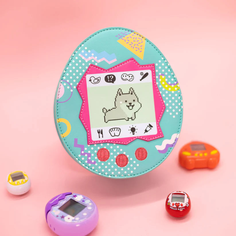 Throwback to the Tamagotchi days! Did you own a virtual pet back in the day? If not, do not worry, we got you covered. Available in cat or dog. Features a zipper closure and adjustable strap.
Dimensions: 7.25” x 3” x 8.5”