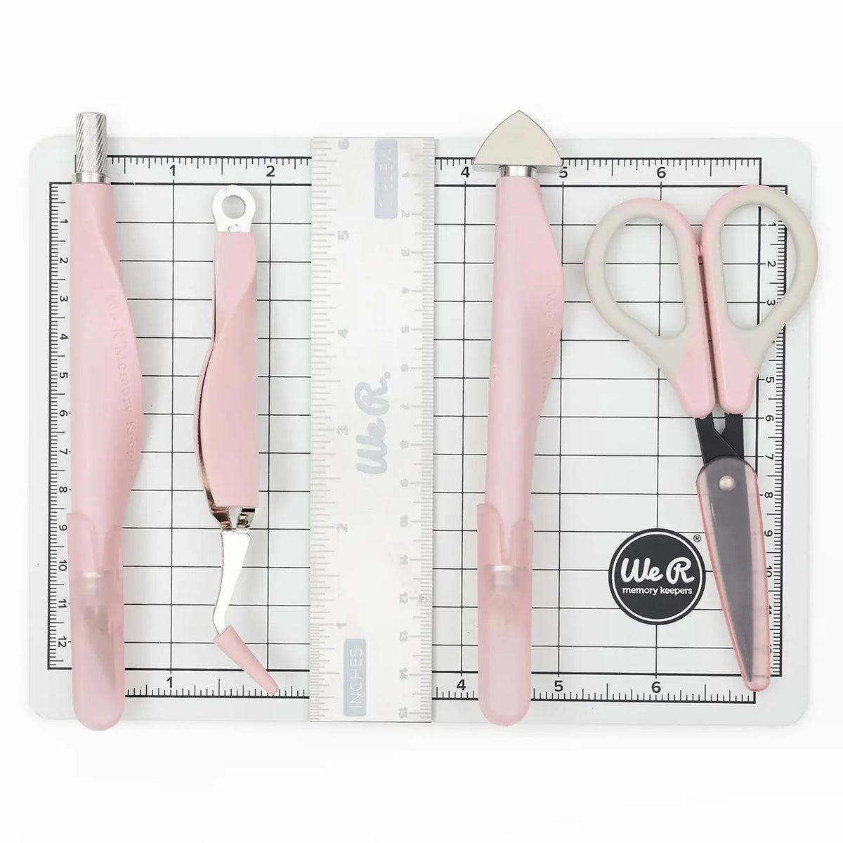 The We R Makers Mini Tool Kit in Pink is the ultimate companion for all your DIY craft projects. This comprehensive kit includes essential tools: a cutting mat, ruler, scissors, craft knife, tweezers, brad setter, and piercing tool. Designed for versatility, it's perfect for scrapbooking, journaling, card making, and a wide range of other crafts.
The vibrant pink color adds a fun and stylish touch to your toolkit, while the high-quality construction ensures each tool is durable and reliable. The cutting ma