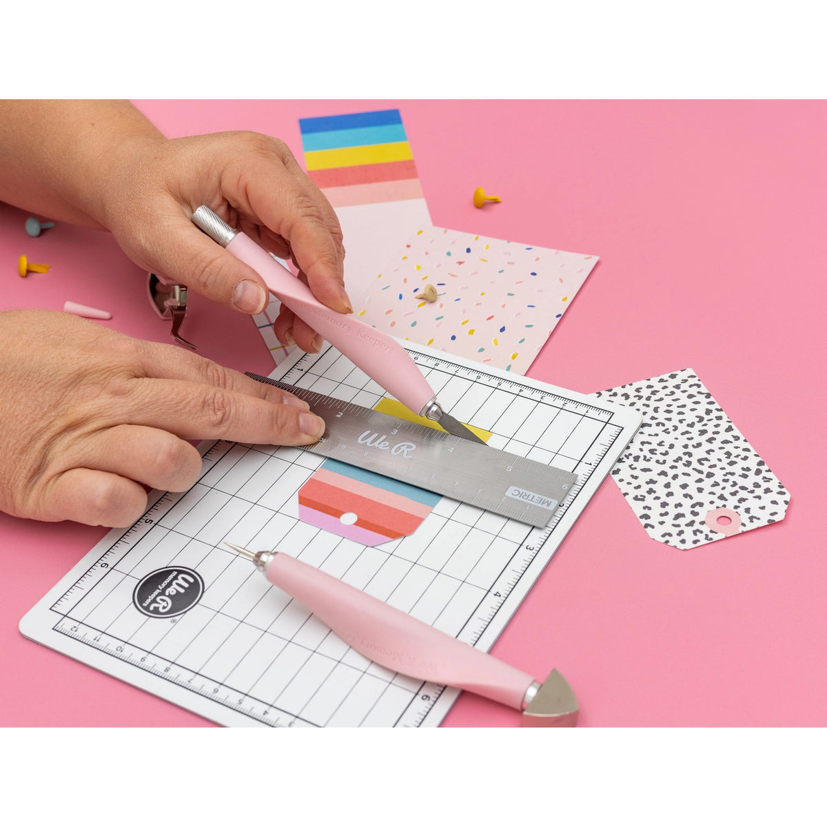 The We R Makers Mini Tool Kit in Pink is the ultimate companion for all your DIY craft projects. This comprehensive kit includes essential tools: a cutting mat, ruler, scissors, craft knife, tweezers, brad setter, and piercing tool. Designed for versatility, it's perfect for scrapbooking, journaling, card making, and a wide range of other crafts.
The vibrant pink color adds a fun and stylish touch to your toolkit, while the high-quality construction ensures each tool is durable and reliable. The cutting ma
