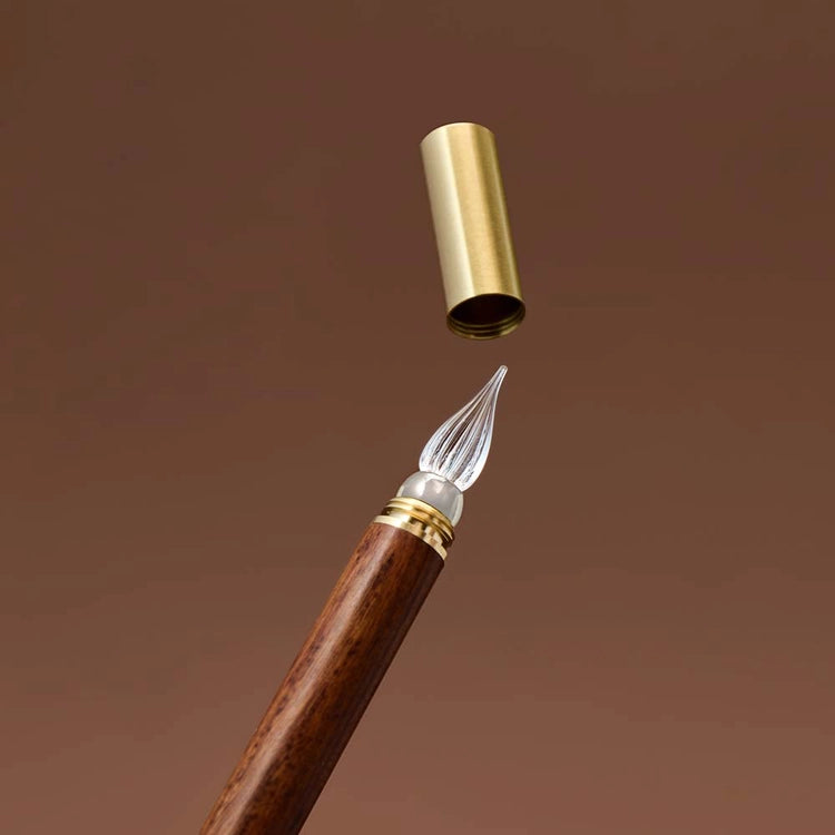 A modular glass pen that combines a glass nib with an elegant rosewood body.
The modular design allows the pen to be used for many years to come due to its easy nib replacement system. Designed to be easy to use and clean, the nib can be detached easily and lightly rinsed with water for cleaning.
The screw on brass cap allows for safe transport and storage making it perfect for use on the go. 