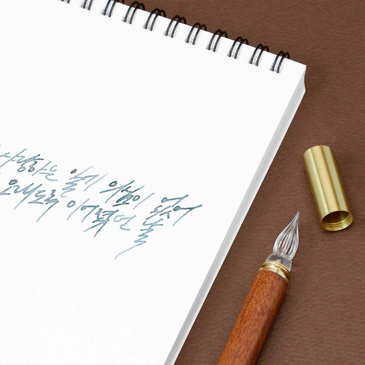 A modular glass pen that combines a glass nib with an elegant rosewood body.
The modular design allows the pen to be used for many years to come due to its easy nib replacement system. Designed to be easy to use and clean, the nib can be detached easily and lightly rinsed with water for cleaning.
The screw on brass cap allows for safe transport and storage making it perfect for use on the go. 