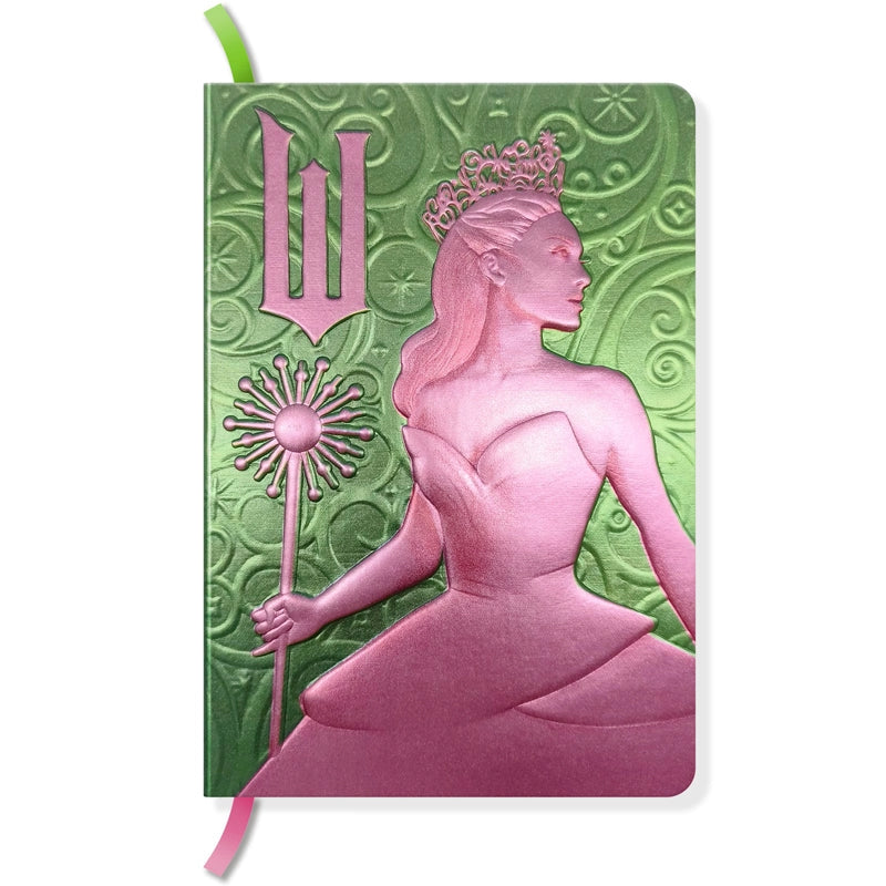 The perfect place to note your thoughts in style, this 184-page collectible journal is a stylish gift for any Wicked fan. This reversible journal can be flipped to present either Elphaba Thropp’s or Glinda Upland’s profiles, with internal pages in soft shades of green and pink and with a satin placeholder ribbon.
QUALITY CONSTRUCTION: This journal features a stunningly detailed, molded hardcover with metallic finish, 184-ruled pages of premium paper, plus a satin ribbon marker to ensure you never lose your