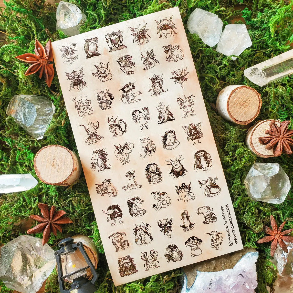 A curious gathering of tiny forest folk fills this sheet, from winged fae and horned creatures to mushroom dwellers, leafy little beings, and a few faces that are wonderfully hard to classify. Delicate sepia linework gives each character its own personality, creating an enchanting collection that feels as though these secretive little residents have been hiding among the moss all along.
One sticker sheet is included.
Top Coating: None
Adhesive Layer: Paper
Backing Layer: Paper
Size: 6.69"x3.54"
Weight-0.3