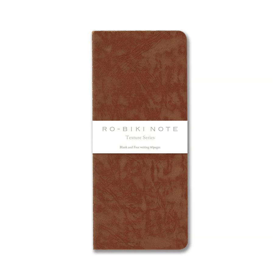 The RO‑BIKI Note is a beautifully crafted Japanese notebook known for its distinctive waxed paper cover, which gains character the more you use it. Over time, the cover softens, develops a natural patina, and becomes uniquely yours—making every notebook feel personal and well‑loved.
Inside, you’ll find high‑quality blank paper ideal for writing, sketching, planning, or journaling. Its compact size makes it perfect for everyday carry, while the durable construction ensures it holds up to frequent use.
Thes