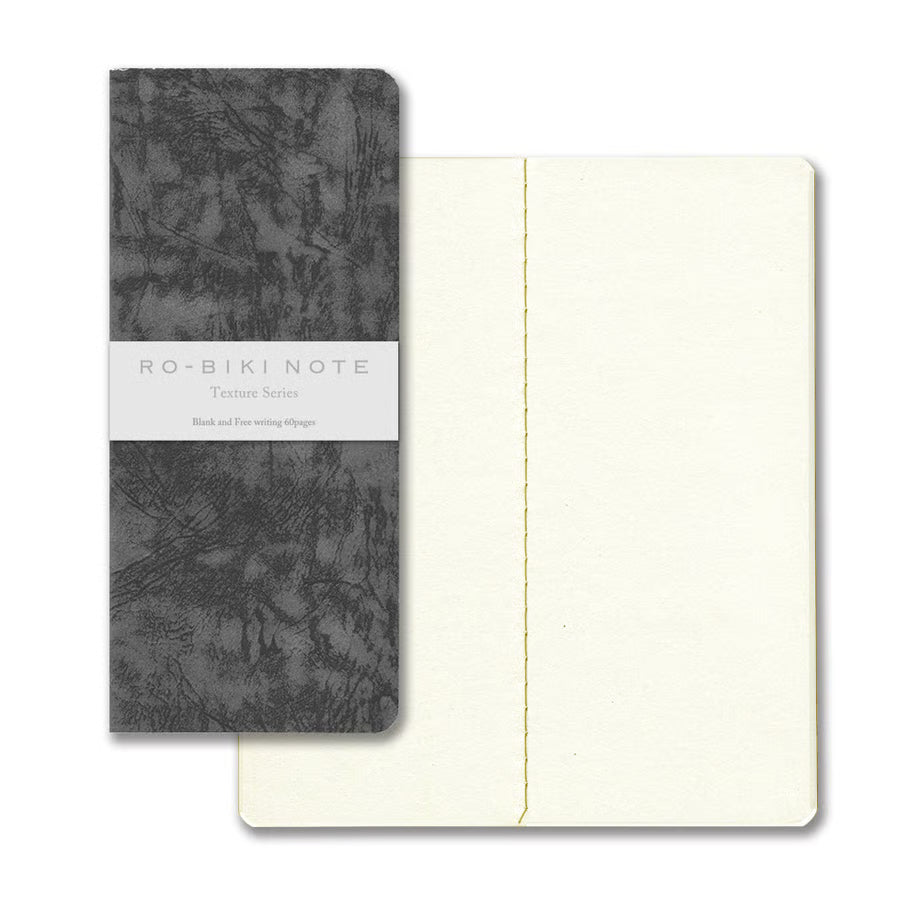 The RO‑BIKI Note is a beautifully crafted Japanese notebook known for its distinctive waxed paper cover, which gains character the more you use it. Over time, the cover softens, develops a natural patina, and becomes uniquely yours—making every notebook feel personal and well‑loved.
Inside, you’ll find high‑quality blank paper ideal for writing, sketching, planning, or journaling. Its compact size makes it perfect for everyday carry, while the durable construction ensures it holds up to frequent use.
Thes