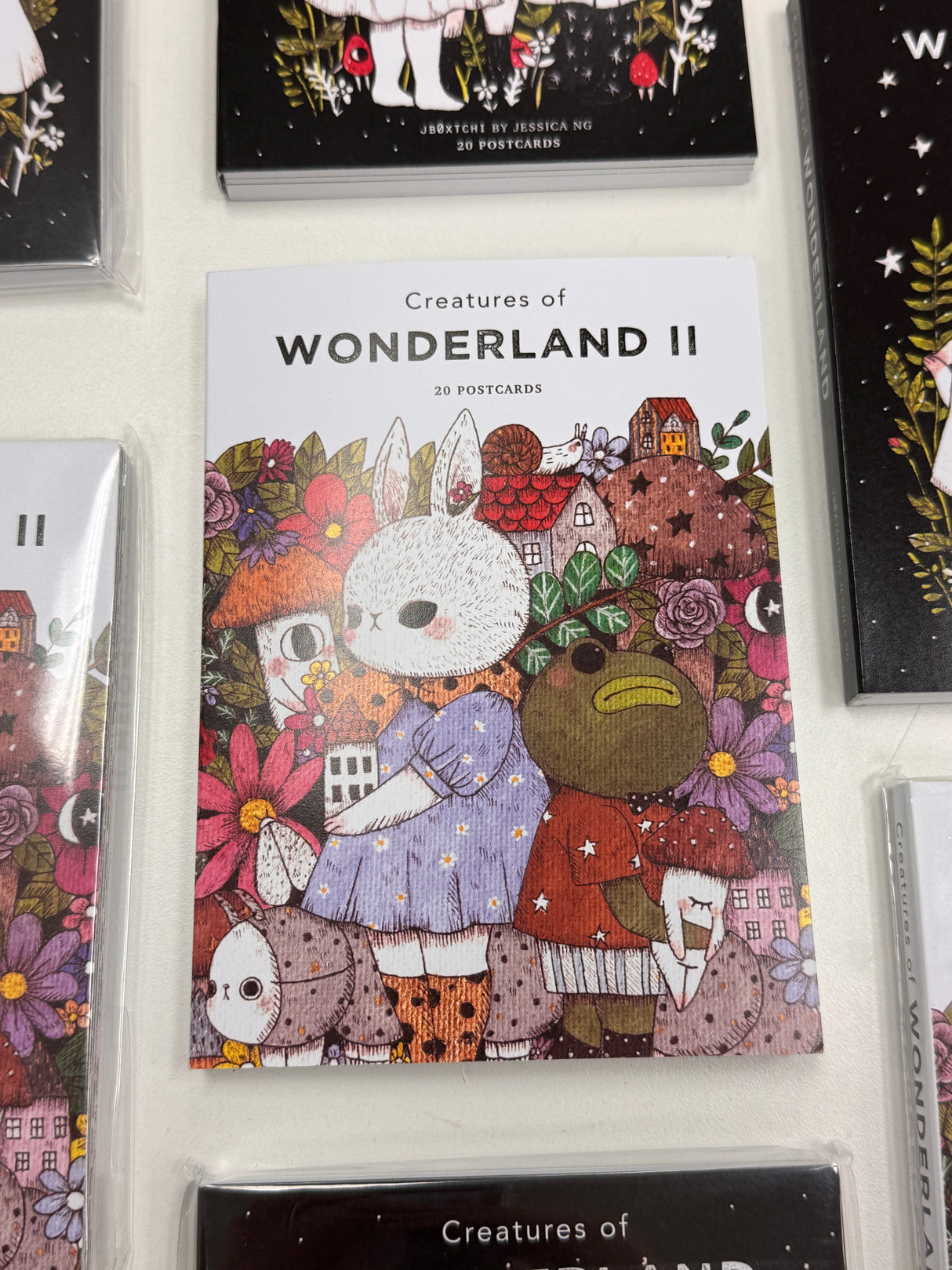 jb0xtchi Postcard Set - Creatures of Wonderland 2
The Creatures of Wonderland 2 Postcard Set includes 20 postcards featuring artwork illustrated by jb0xtchi (Jessica Ng). jb0xtchi creates stationary and small trinkets from whimsical ideas in the form of painting using ink, watercolor, and gouache.
6in x 4in postcards
20 different designs
All artwork done by Jessica Ng