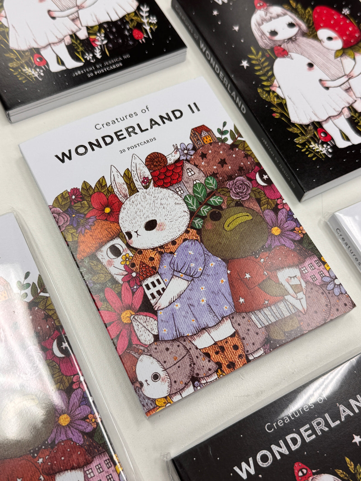 jb0xtchi Postcard Set - Creatures of Wonderland 2
The Creatures of Wonderland 2 Postcard Set includes 20 postcards featuring artwork illustrated by jb0xtchi (Jessica Ng). jb0xtchi creates stationary and small trinkets from whimsical ideas in the form of painting using ink, watercolor, and gouache.
6in x 4in postcards
20 different designs
All artwork done by Jessica Ng