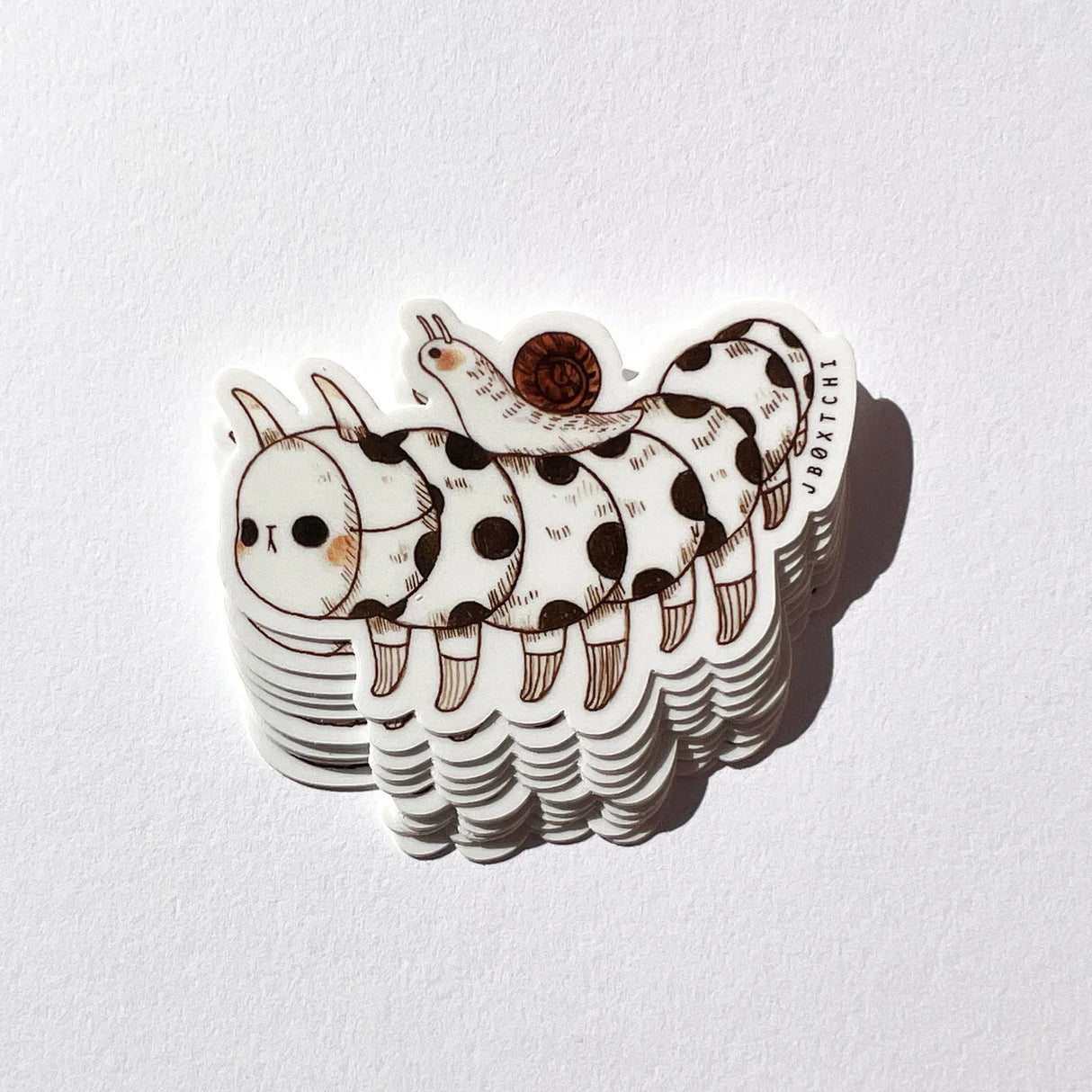 The caterpillar vinyl sticker was illustrated by jb0xtchi (Jessica Ng). jb0xtchi creates stationary and small trinkets from whimsical ideas in the form of painting using ink, watercolour, and gouache.