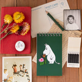 Inspired by Tove Jansson’s beloved world, this collection celebrates the beauty of a slower, gentler way of living where simple pleasures like a warm cup of tea, a quiet walk, and time spent with friends mean everything. Each piece reflects the spirit of Moominvalley: thoughtful, whimsical, and rooted in everyday joy.
