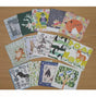 Collection of animal-themed greeting cards on a wooden surface