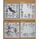 Four sheets of paper with floral and animal designs on a wooden surface