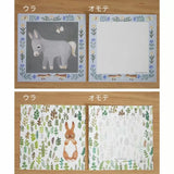 Two sets of paper with animal illustrations on a wooden surface