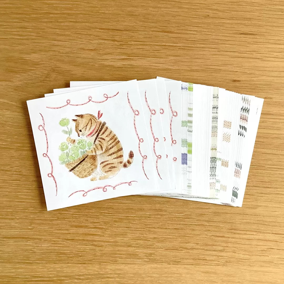 Set of greeting cards with a cat illustration on a wooden surface