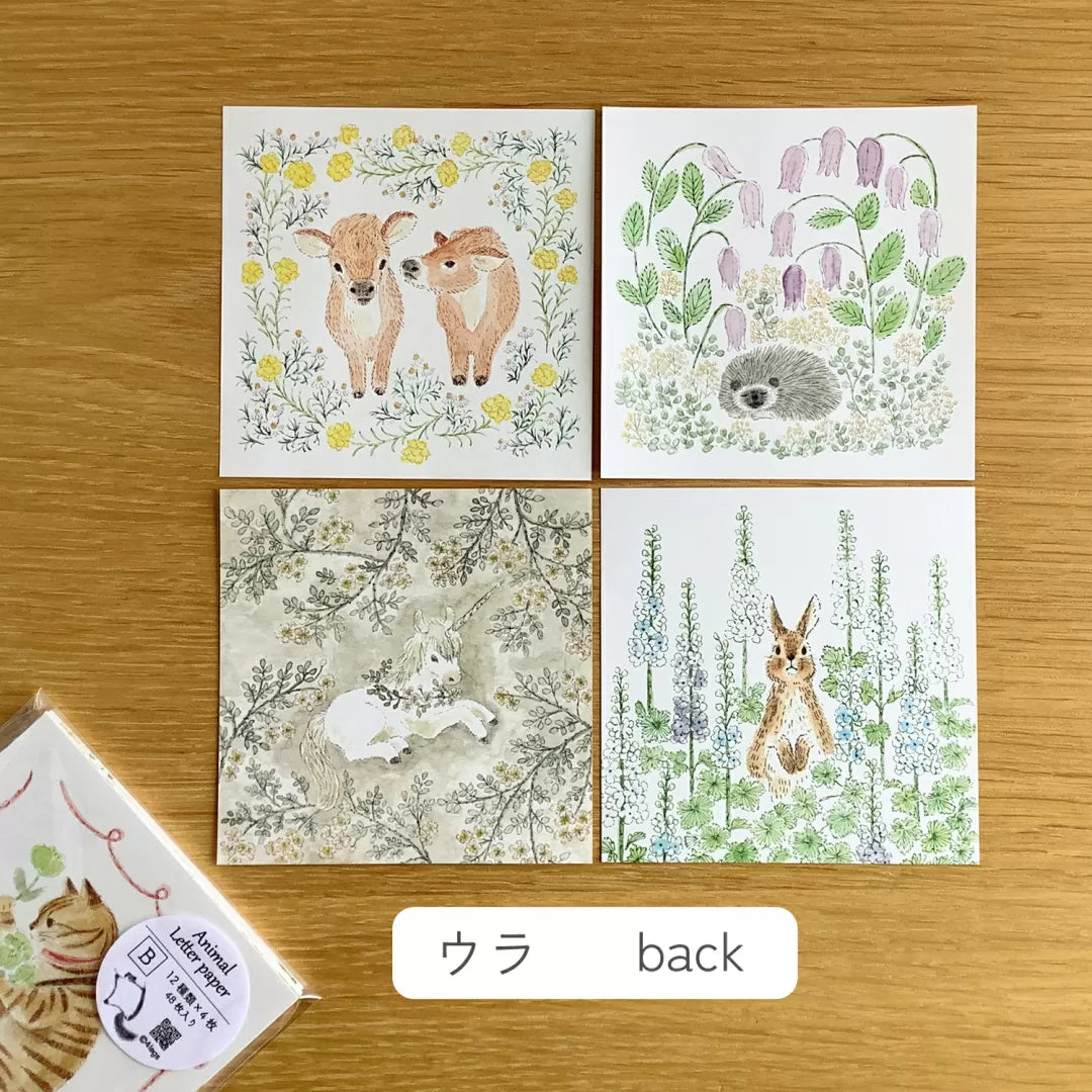 4legs Animal Letter Paper Set B (48 sheets) Four forest-themed greeting cards with animals on a wooden surface.