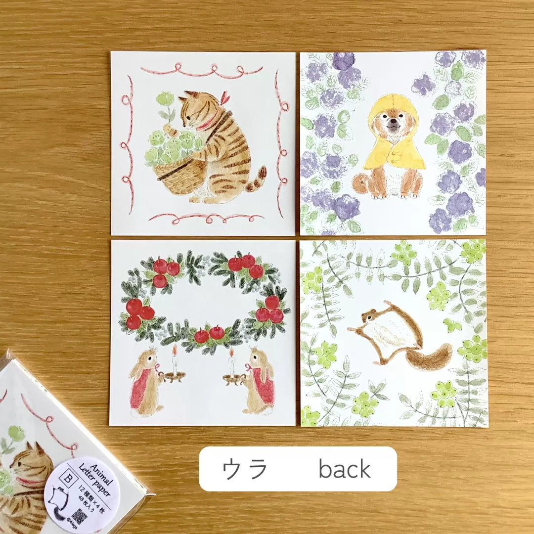 Set of four animal-themed cards on a wooden surface with 'ウラ back' label.