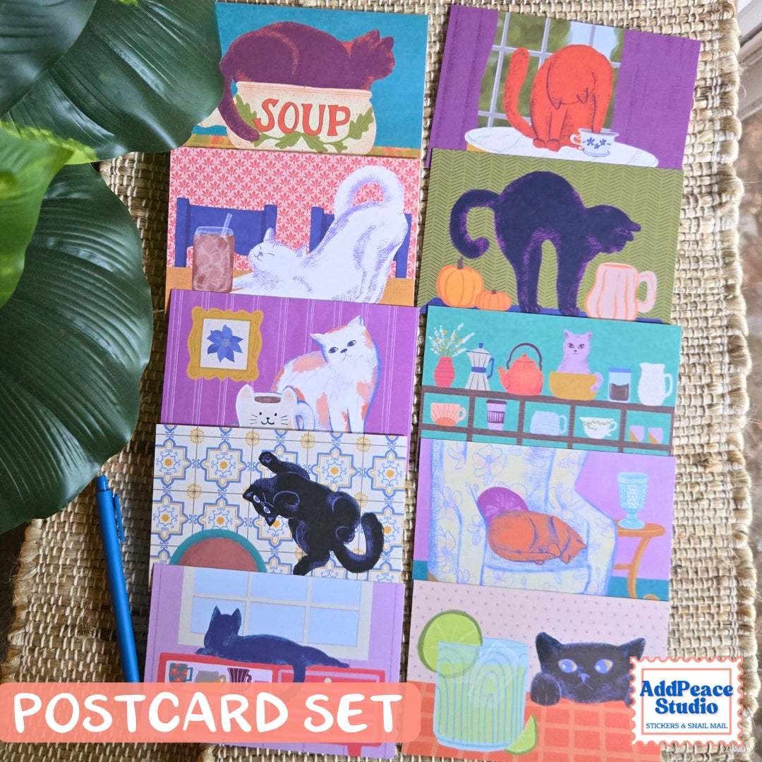 AddPeace Studio - Cats &amp; Cups Postcard Pack

A charming illustrated postcard set for cat lovers, homebodies, and anyone craving a little analog joy. This Cats &amp; Cups postcard pack celebrates quiet moments, warm drinks, and the simple pleasure of sending real mail. Designed for the current resurgence of snail mail, pen pals, and intentional connection, these postcards make it easy (and fun) to go offline on purpose.

Each set includes ten unique 4x6 postcards featuring original Cats &amp; Cups illust