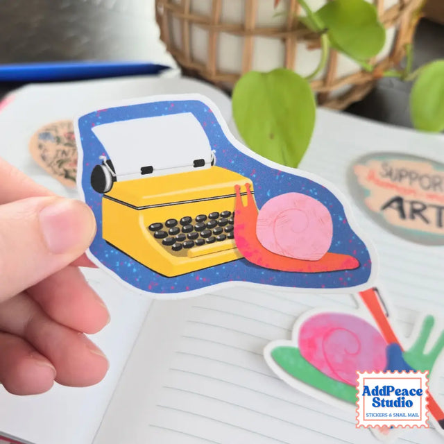 AddPeace Studio - Snail At Typewriter Vinyl Sticker

This illustrated sticker features a snail at a bright yellow typewriter, fully immersed in the writing process and bringing big creative ideas to life.

Details:


Size: 2.5"
Material: Waterproof, scratch-resistant matte vinyl

Made in USA, original artwork by AddPeace Studio