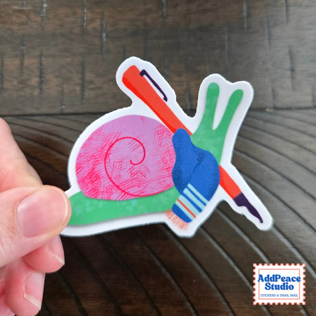 AddPeace Studio - Writing Snail Vinyl Sticker

This illustrated sticker features a snail wrapped in a scarf and holding a fountain pen, fully in its element. Thoughtful, creative, and a little poetic, it’s made for anyone who feels at home with pen in hand and ideas waiting to be written.

Details:


Size: 2.5"
Material: Waterproof, scratch-resistant matte vinyl

Made in USA, original artwork by AddPeace Studio