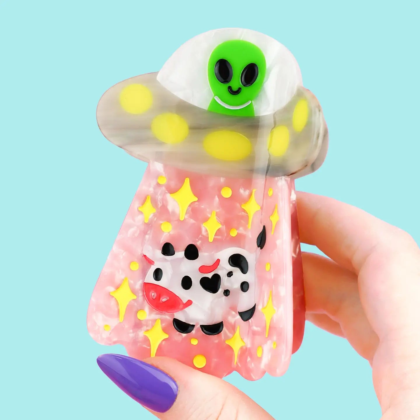 Alien UFO Hair Claw' Hair Accessory by Turtle's Soup.

Includes one (1) hair claw
Claw is roughly 3"
3D, engraved, printed, and painted details
High quality acetate material, stronger than standard hair clips
Themed packaging