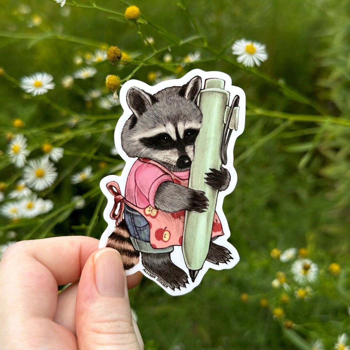 This little raccoon is ready to doodle or write in their planner with their pen!

Original artwork hand-drawn in pencil by Allison Stoiser.