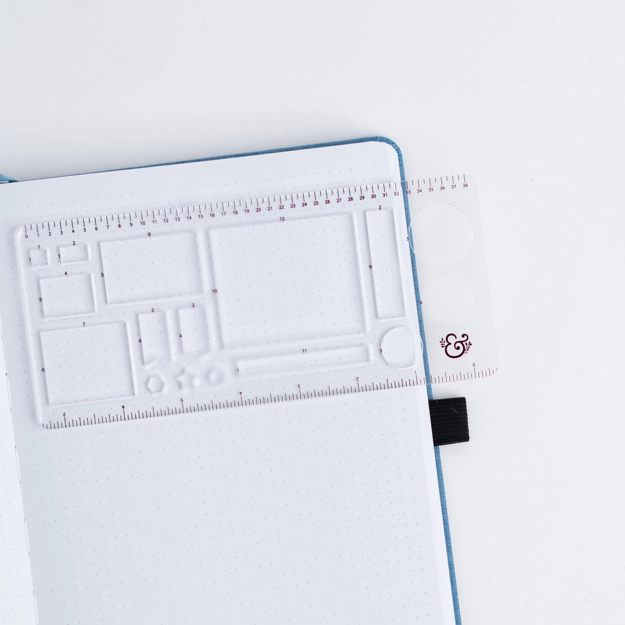 Get precise and achieve perfect outlines in your journal with our A5 Dot Grid Planning Stencil. This handy grid spacing guide helps you measure out your bullet journal spreads with ease. Simply pick a layout and use the dot grid journal ruler to mark out each box.

The stencil features half square notches, guide boxes, helpful shapes, and more so you can quickly create an entire journaling spread without the worry of counting dots or having uneven lines!

This stencil is particularly helpful for A5 notebook