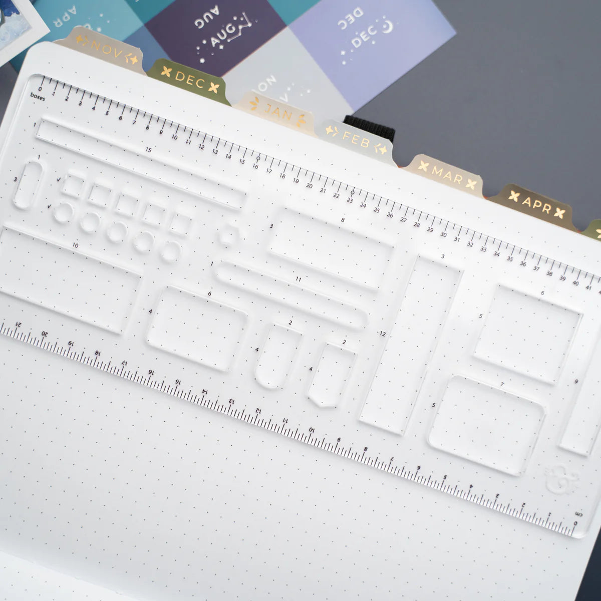 This clear B5 Dot Grid Planning Stencil helps you measure out your bullet journal spreads with ease. New and improved with thicker plastic to help you get precise and achieve perfect outlines in your journal with our stencil.

The stencil features guide boxes, helpful shapes, and more so you can quickly create an entire journaling spread without the worry of counting dots or having uneven lines!

This stencil is particularly helpful for B5 notebooks as you can use the circle guides to find the center of a B