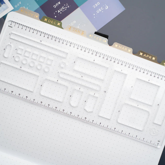 This clear B5 Dot Grid Planning Stencil helps you measure out your bullet journal spreads with ease. New and improved with thicker plastic to help you get precise and achieve perfect outlines in your journal with our stencil.

The stencil features guide boxes, helpful shapes, and more so you can quickly create an entire journaling spread without the worry of counting dots or having uneven lines!

This stencil is particularly helpful for B5 notebooks as you can use the circle guides to find the center of a B