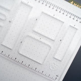 This clear B5 Dot Grid Planning Stencil helps you measure out your bullet journal spreads with ease. New and improved with thicker plastic to help you get precise and achieve perfect outlines in your journal with our stencil.

The stencil features guide boxes, helpful shapes, and more so you can quickly create an entire journaling spread without the worry of counting dots or having uneven lines!

This stencil is particularly helpful for B5 notebooks as you can use the circle guides to find the center of a B