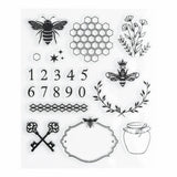 A charming clear stamp set inspired by classic beekeeping motifs and vintage apothecary details. Featuring bees, honeycomb, wildflowers, ornate keys, numerals, and decorative labels, this set brings a playful yet timeless touch to journaling and creative spreads.

Specs &amp; Details:

Stamp Type: Clear, reusable acrylic stamps
Design Theme: Bees, honeycomb, florals, vintage keys, labels, numbers
Material: High-quality photopolymer
Use: Ideal for reading journals, planners, book reviews, and creative spread