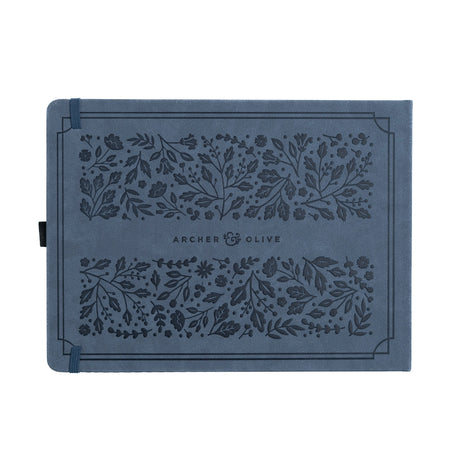 Introducing the&nbsp;Heirloom&nbsp;notebook.&nbsp;This&nbsp;Letter Sized&nbsp;notebook is truly special,&nbsp;featuring a unique full cover design. The&nbsp;intricate foliage pattern and fountain pen is&nbsp;debossed&nbsp;on a&nbsp;suede-like blue vegan leather cover,&nbsp;finished with&nbsp;a vintage&nbsp;rose gold stamping.


This notebook comes with the choice of&nbsp;Dot Grid&nbsp;or&nbsp;Lined&nbsp;pages, and is the perfect journal for a special occasion. From a memory keeping scrapbook to wedding gues