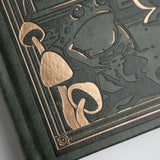 The Apothecary Shelf Notebook invites you into an enchanted workshop filled with mysterious bottles, magical herbs, curious mushrooms, and hidden woodland treasures.
