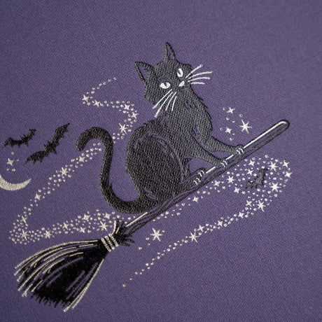 The Bewitched Notebook captures the playful spirit of Halloween with a charming black cat perched atop a broomstick beneath a crescent moon, surrounded by twinkling stars and fluttering bats.