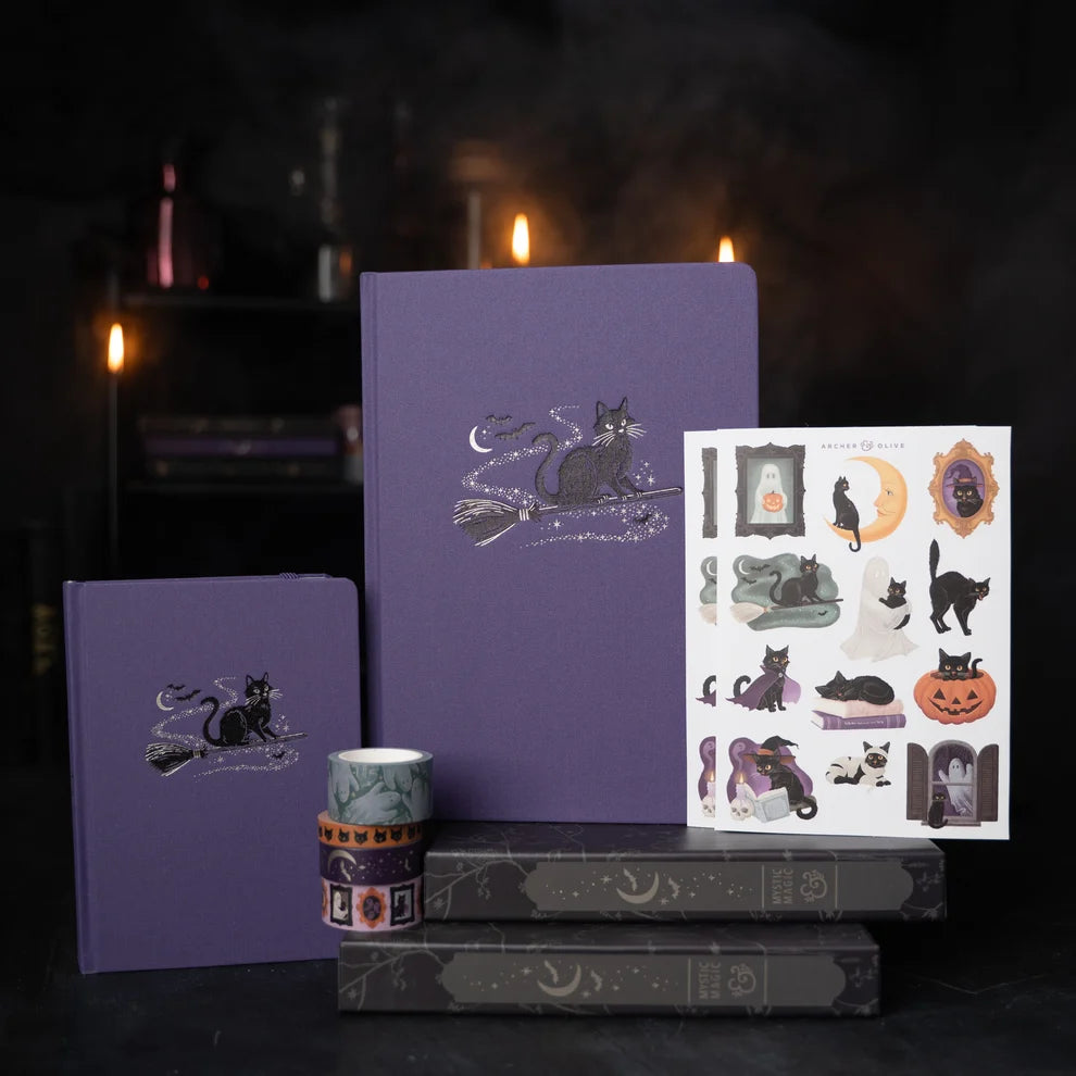 The Bewitched Notebook captures the playful spirit of Halloween with a charming black cat perched atop a broomstick beneath a crescent moon, surrounded by twinkling stars and fluttering bats.