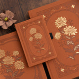 🌼&nbsp;Chrysanthemum Notebook
A celebration of stillness, beauty, and the shift in seasons. The Chrysanthemum Notebook features a warm rust-toned vegan leather cover, intricately debossed and accented with radiant gold foil. Inspired by late-blooming florals, this design invites reflection, creativity, and calm.

Inside, you’ll find ultra-thick 160gsm paper that holds up to your favorite pens, markers, and creative materials without bleeding. Whether you're journaling your thoughts or sketching quiet momen