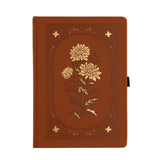 🌼&nbsp;Chrysanthemum Notebook
A celebration of stillness, beauty, and the shift in seasons. The Chrysanthemum Notebook features a warm rust-toned vegan leather cover, intricately debossed and accented with radiant gold foil. Inspired by late-blooming florals, this design invites reflection, creativity, and calm.