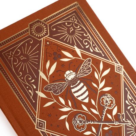 Let your creativity buzz with warmth and intention. The Keeper of the Bees Notebook in Rust blends golden honeybee symbolism with rich, earthy tones, creating a journal that feels both enchanting and grounding. Perfect for capturing ideas, documenting your days, or exploring your imagination—this notebook turns every page into a moment of magic.