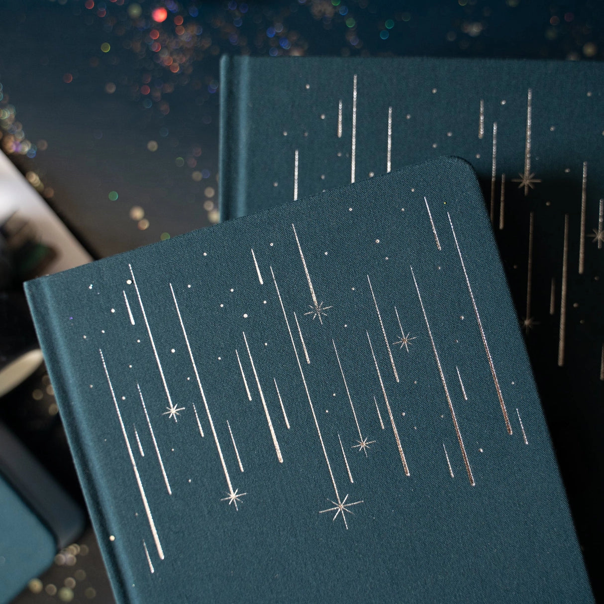 Quiet, expansive, and full of wonder — the Meteor Shower Notebook captures the magic of watching the night sky come alive. A deep, moody cover is scattered with delicate shooting stars, creating a sense of calm movement and cosmic possibility. It’s a notebook made for late-night thoughts, creative sparks, and ideas that arrive like falling stars.