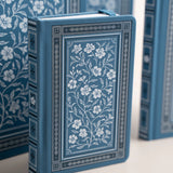 Wild Periwinkle Notebook

Let your creativity unfurl like a field of wildflowers. The Wild Periwinkle Notebook pairs soft blue tones with delicate white florals, creating a peaceful place to gather your thoughts, start new projects, and savor quiet moments of reflection. It’s a beautifully timeless companion for journaling, planning, or everyday inspiration.