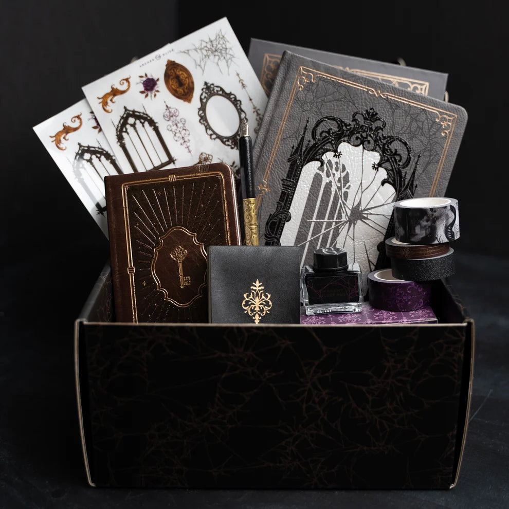 Unlock a world of haunting beauty with the Whispering Walls Halloween Box, an exclusive collection designed for journalers who adore gothic elegance and vintage mystery.