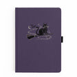 The Bewitched Notebook captures the playful spirit of Halloween with a charming black cat perched atop a broomstick beneath a crescent moon, surrounded by twinkling stars and fluttering bats.