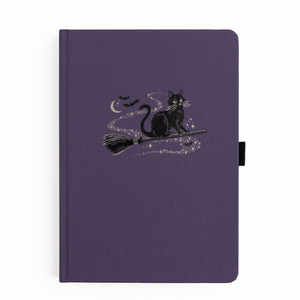 The Bewitched Notebook captures the playful spirit of Halloween with a charming black cat perched atop a broomstick beneath a crescent moon, surrounded by twinkling stars and fluttering bats.