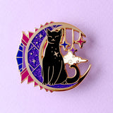 This celestial Art Deco Moon Cat is perfect for cat lovers everywhere!

It features a black cat standing on a moon filled with purple art deco shapes, with falling stars in the background.

The pin is secured by two purple heart backs and comes on a special ‘Art Deco’ Glitter Punk backing card, making it perfect for a gift or to keep as a special treat for yourself.

This pin is part of my Art Deco Cats collection – 8 enamel pins based on the fabulous 20th century visual arts movement. 

Measurements: 45mm