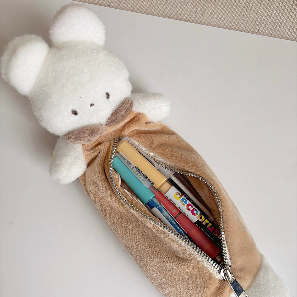 Keep your pens, pencils, and small essentials organized with this soft and fuzzy pencil pouch! With approximately 5.5 inches of storage space, it's perfect for carrying stationery, makeup brushes, or other daily must-haves. Its compact and lightweight design makes it easy to slip into your bag, while the sturdy zipper closure keeps everything secure.